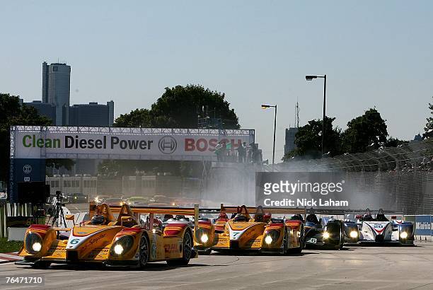 Ryan Briscoe driver of the Penske Racing Porsche RS Spyder leads the pack into the first corner on the first lap of the American Le Mans Series,...