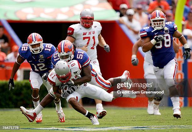 Brandon Spikes the Florida Gators tackles Jessie Quinn of the Western Kentucky Hilltoppers on September 1, 2007 at Ben Hill Griffin Stadium in...