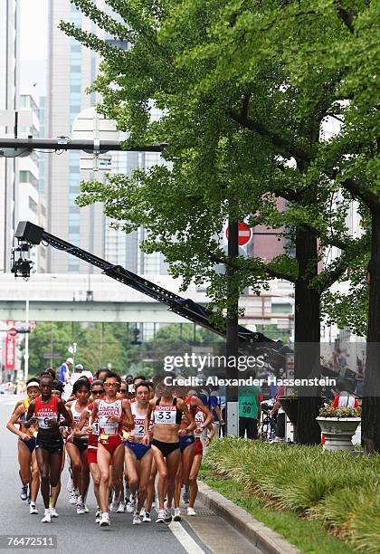 Athletes led by Yumiko Hara of Japan and Nina Rillstone of New Zealand make their way through the streets of Osaka while competing in the Women's...