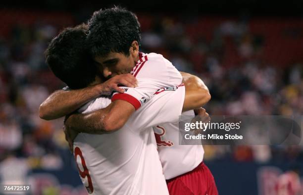 Juan Pablo Angel of the New York Red Bulls celebrate his second half goal with teammate Claudia Reyna against the Chicago Fire at Giants Stadium in...