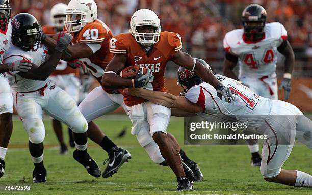 Wide recevier Quan Cosby of the Texas Longhorns runs the ball against Brett Shrable of the Arkansas State Indians in the second quarter at Texas...