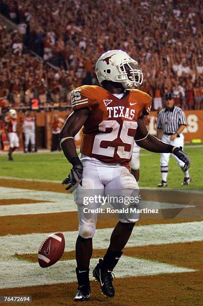 Running back Jamaal Charles of the Texas Longhorns celebrates a touchdown against the Arkansas State Indians in the third quarter at Texas Memorial...
