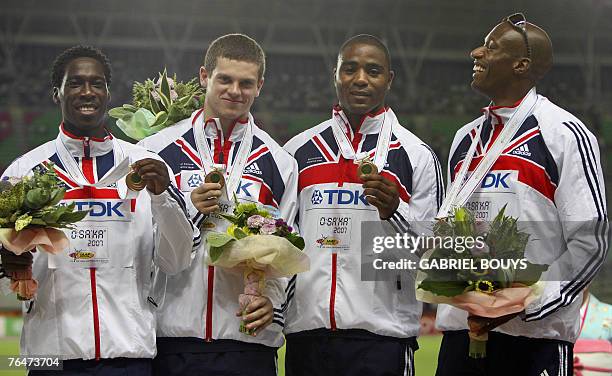 Britain's Christian Malcolm, Craig Pickering, Mark Lewis-Francis and Marlon Devonish pose during the men's 4x100m relay medal ceremony at the 11th...