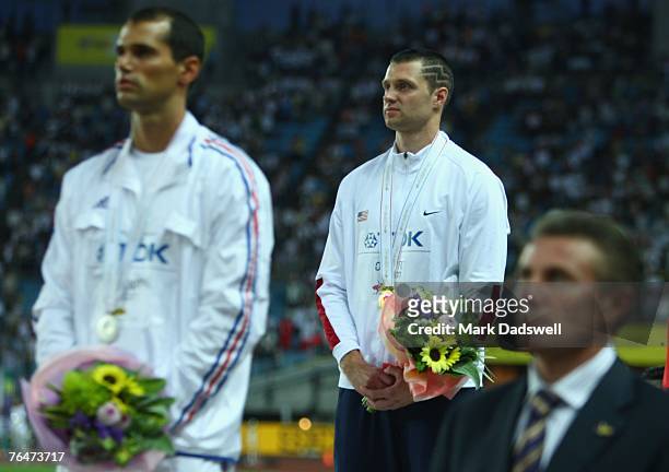 Former champion Sergei Bubka stands for the American anthem as Brad Walker of the United States of America receives his gold medal for winning the...