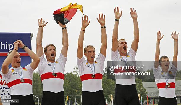 Germany's Florian Mennigen, Stephan Koltzk, Philipp Naruhn, Matthias Flach, and cox Martin Sauer celebrate their third place on the podium in the...
