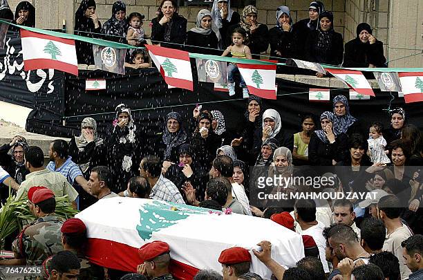 Lebanese civilians mourn during the funeral procession for Lebanese army officer Ali Nassar in the village of Kfar Hata south of Beirut, 02 September...