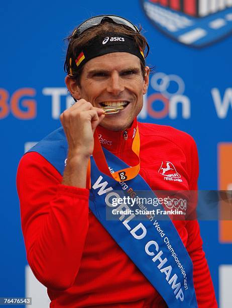 Daniel Unger of Germany bites his medal after winning the Triathlon World Championships on September 2, 2007 in Hamburg, Germany.