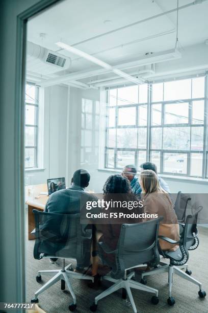 business people on video conference behind window - texas conference for women 2017 stock pictures, royalty-free photos & images