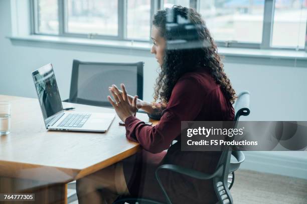 mixed race businesswoman on video conference - texas conference for women 2017 stock pictures, royalty-free photos & images