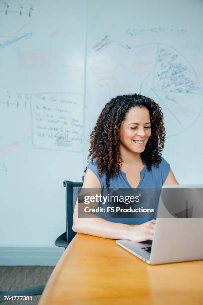 mixed race businesswoman using laptop - texas conference for women 2017 stock pictures, royalty-free photos & images