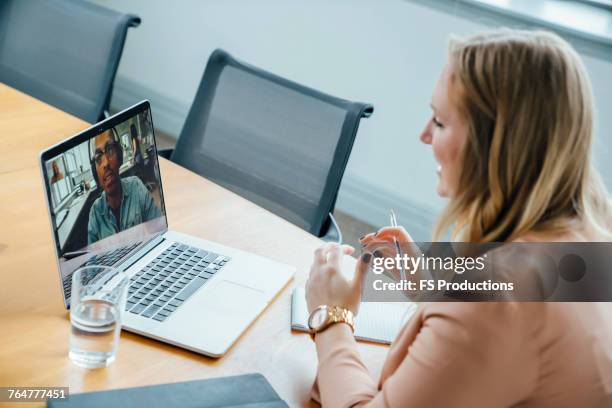business people on video conference - working behind laptop stockfoto's en -beelden