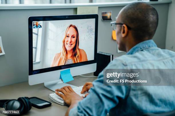 business people on video conference - over the shoulder view stock pictures, royalty-free photos & images