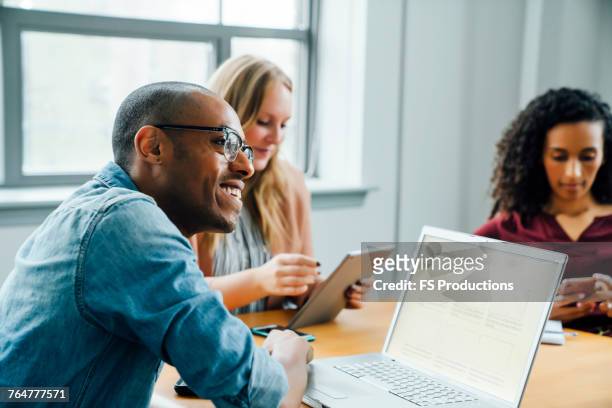 business people using technology in meeting - african american and happy and close up and office stock pictures, royalty-free photos & images