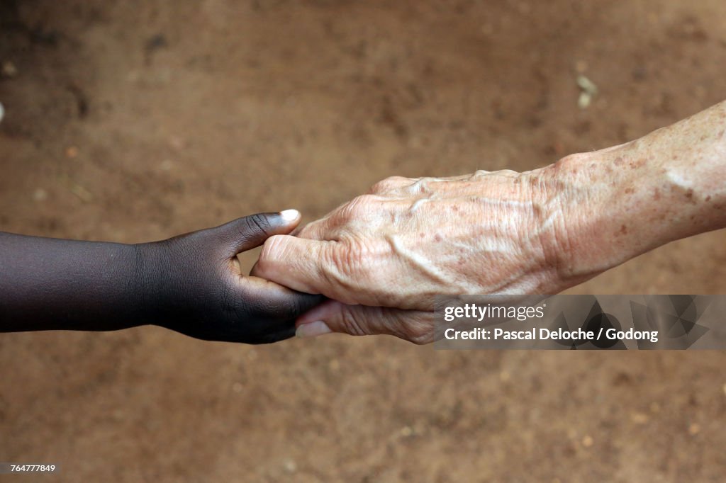 Humanitarian Worker Holding Childs Hand. Togo.