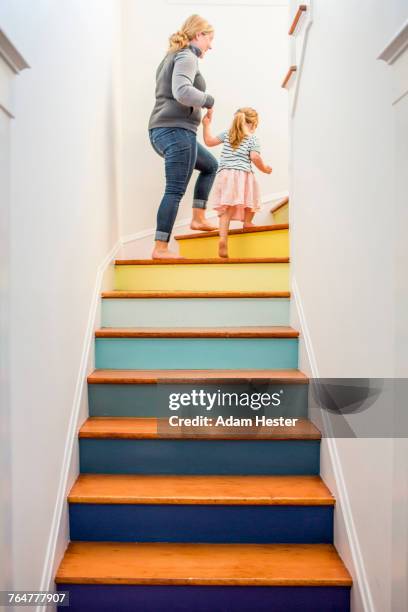 caucasian mother and daughter climbing multicolor staircase - tree house stockfoto's en -beelden