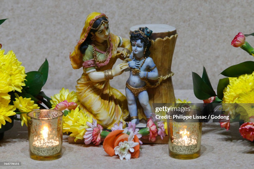 Statues and flowers in the Leicester ISKCON temple. Krishna with his mother. United kingdom.