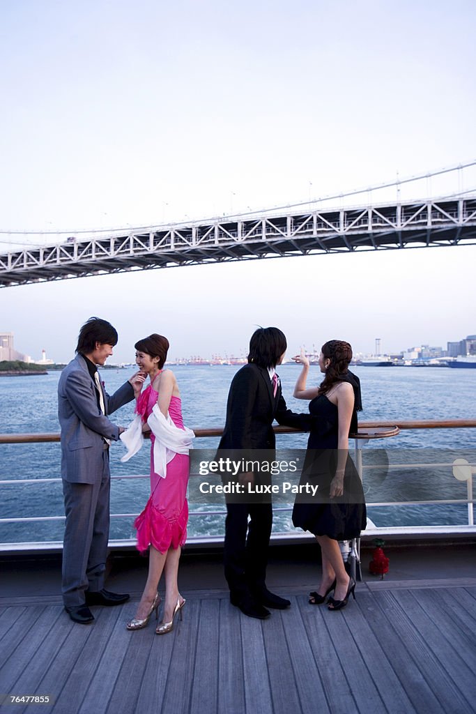 Two couples enjoying the view on cruise ship, low angle view