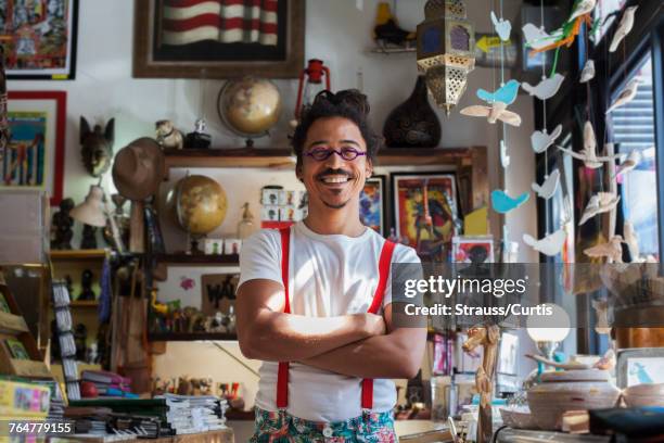 smiling mixed race man wearing suspenders - besonders stock-fotos und bilder