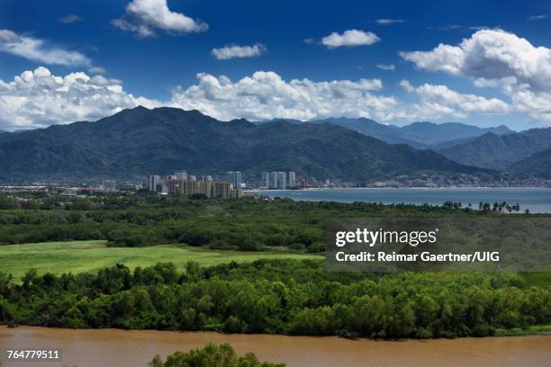 view of puerto vallarta over the ameca river with sierra madre mountains - nuevo vallarta stock pictures, royalty-free photos & images