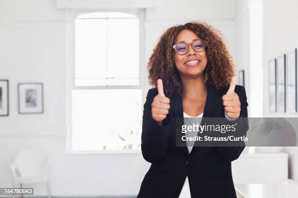 mixed race woman gesturing in gallery - incoraggiamento foto e immagini stock