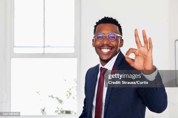 black man gesturing okay in gallery - ok sign stock pictures, royalty-free photos & images