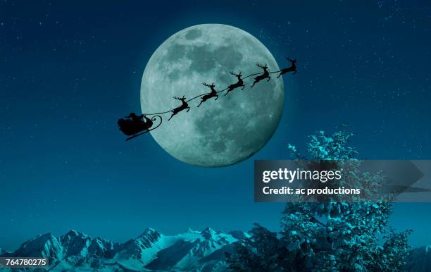 silhouette of santa and reindeer flying sleigh near full moon - moon landscape stock pictures, royalty-free photos & images