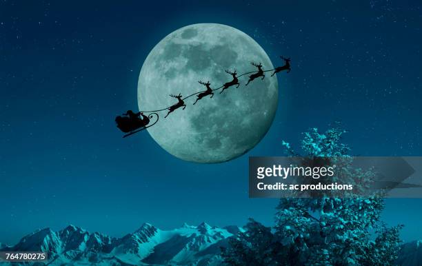silhouette of santa and reindeer flying sleigh near full moon - reindeer 個照片及圖片檔
