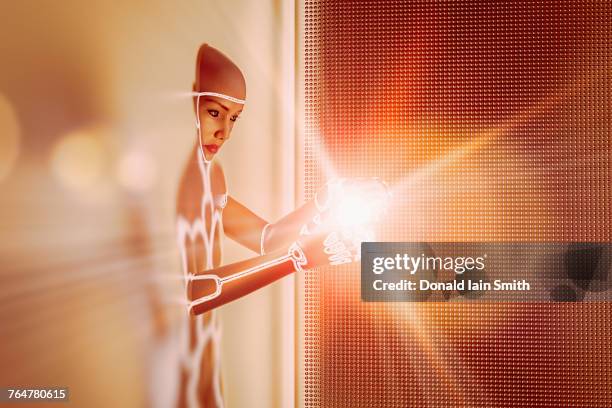 light glowing in hands of futuristic woman emerging from wall - appearance stock-fotos und bilder
