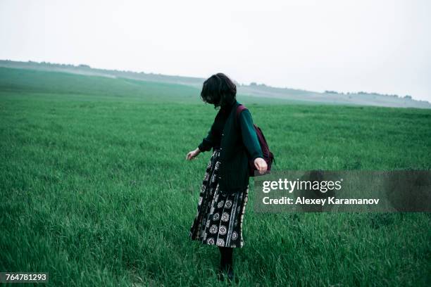 caucasian woman standing in field of grass - simferopol stock pictures, royalty-free photos & images
