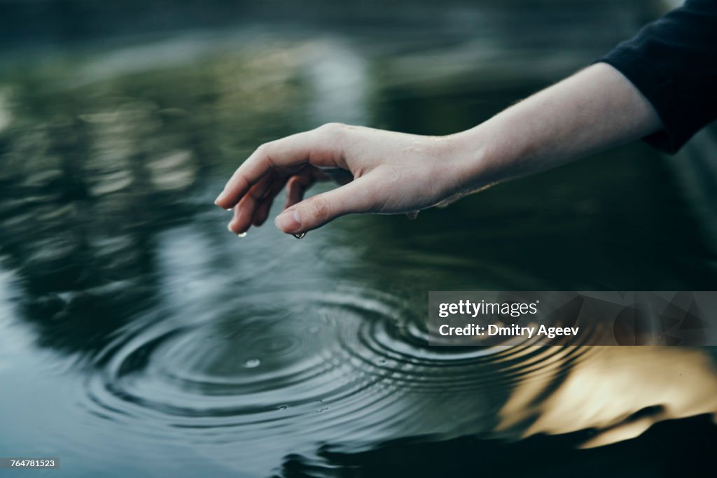 Water dripping from hand of woman