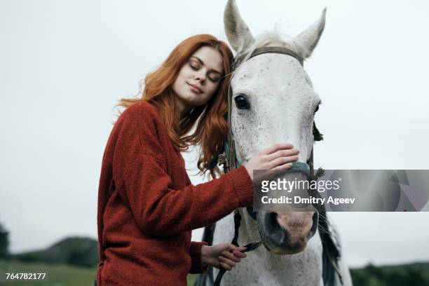 caucasian woman petting horse - dressage horse russia bildbanksfoton och bilder