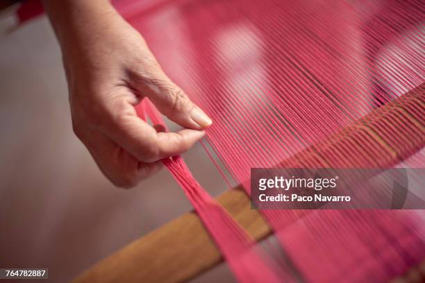 hand of hispanic woman weaving fabric on loom - タペストリー ストックフォトと画像