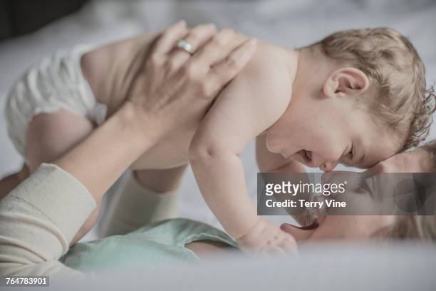 caucasian mother rubbing noses with baby boy - bébé rire photos et images de collection