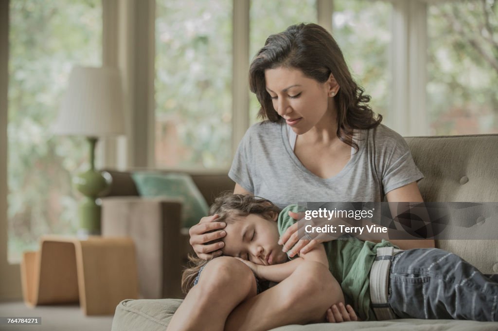 Sleeping boy laying in lap of mother