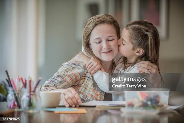 caucasian girl kissing cheek of mother - cheek texas stock pictures, royalty-free photos & images