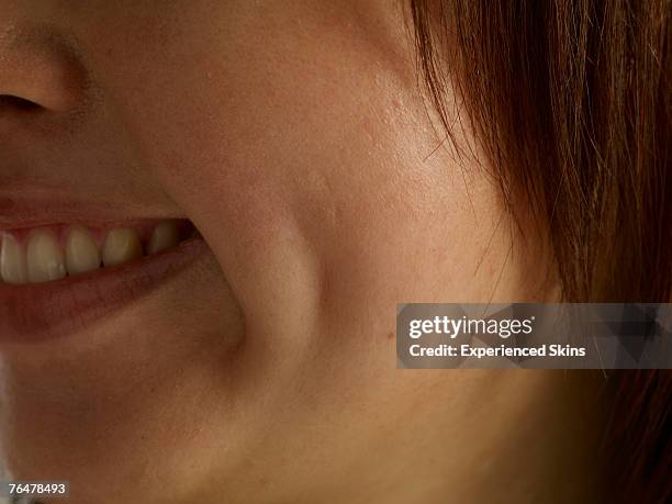 close-up of woman's face, side profile - grübchen stock-fotos und bilder