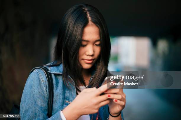 teenage girl using smart phone in city - ot ストックフォトと画像