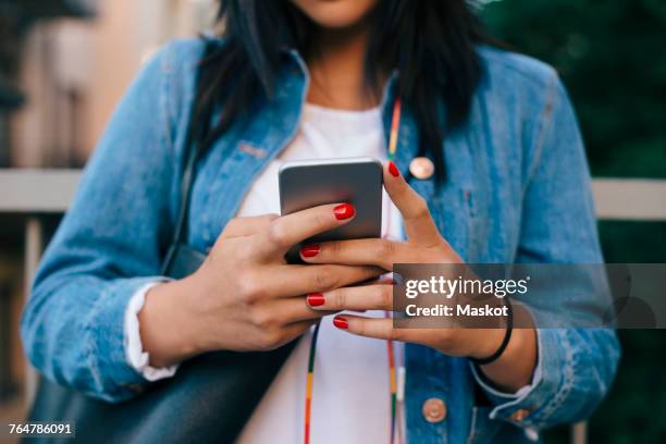 midsection of teenage girl using smart phone - one teenage girl only stock pictures, royalty-free photos & images