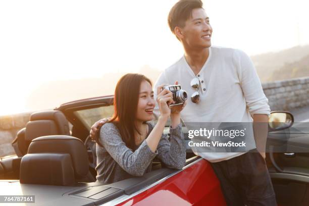 young couple driving - asian couple car stock pictures, royalty-free photos & images