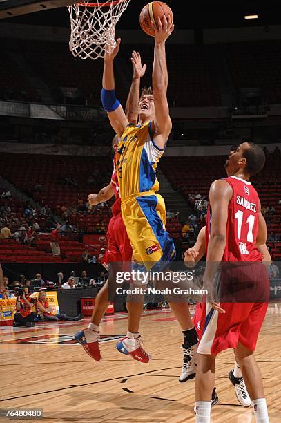 Tiago Splitter of Brazil shoots against Ricardo Sanchez of Puerto Rico during the bronze medal game of the 2007 FIBA Americas Championship at the...