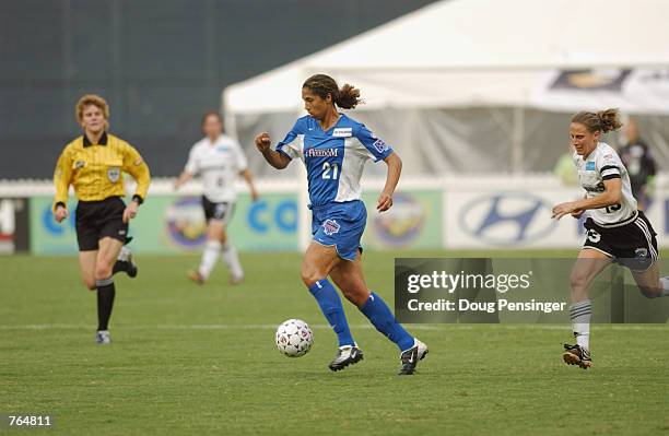 Steffi Jones of the Washington Freedom dribbles the ball with Kristine Lilly of the Boston Breakers in pursuit during the WUSA match on June 12, 2002...