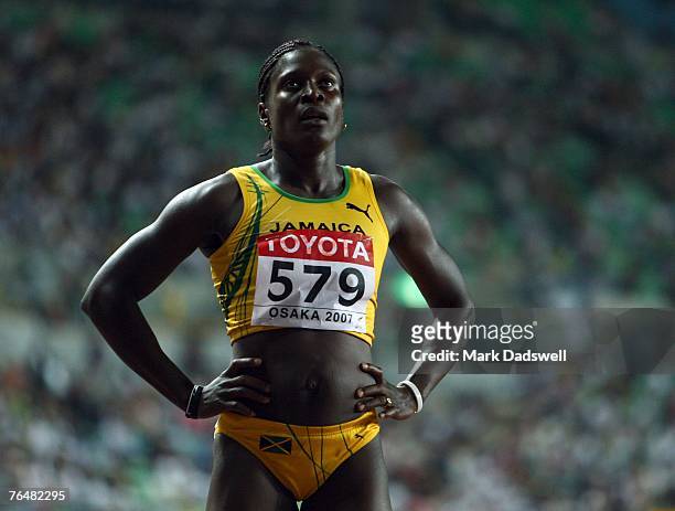 Delloreen Ennis-London of Jamaica checks the timing screen that show she took the third place in the Women's 100m Hurdles Final on day five of the...