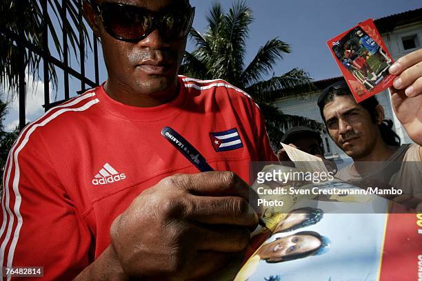 Felix Savon, Cuba`s heavyweight boxer and multiple World Champion and Olympic Gold Medal winner, signs autographs during an activity run by the UJC,...