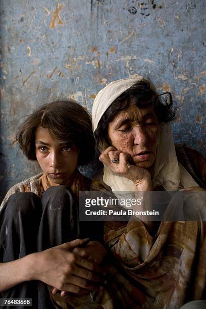 Sabera sits along side her daughter Gulparai August 27, 2007 in Kabul, Afghanistan. Sabera, a widow, has been smoking for four years since she lost...
