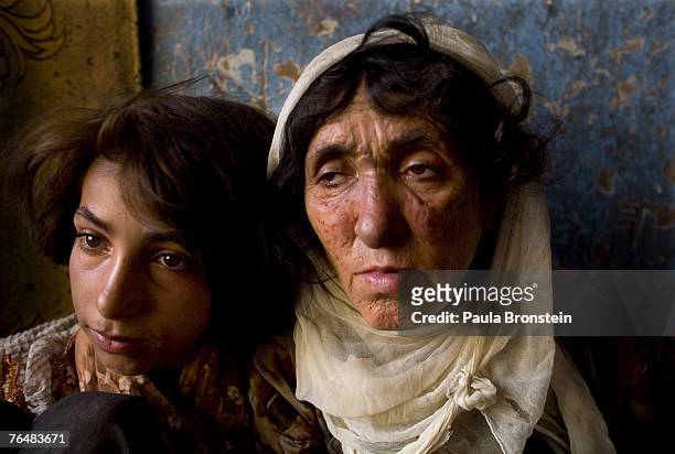 Sabera sits along side her daughter Gulparai August 27, 2007 in Kabul, Afghanistan. Sabera, a widow, has been smoking for four years since she lost...