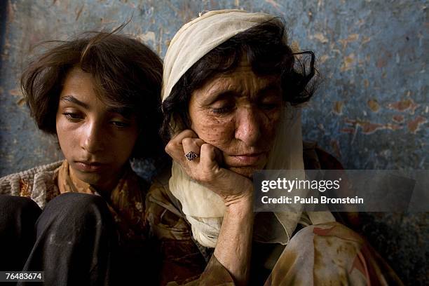 Sabera sits along side her daughter Gulparai August 27, 2007 in Kabul, Afghanistan. Sabera, a widow, has been smoking for four years since she lost...