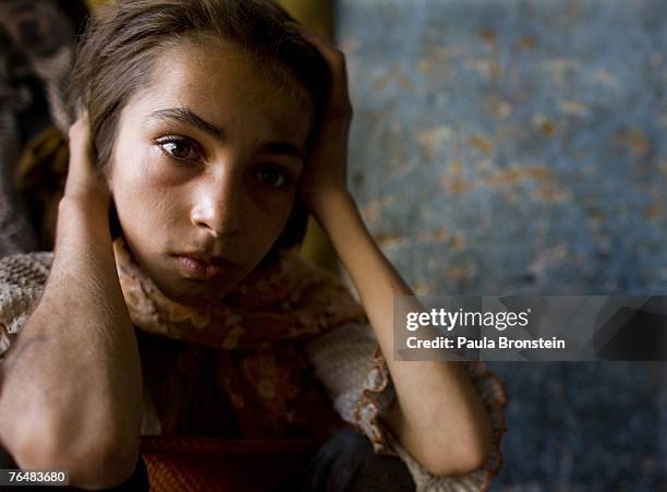 Gulparai looks on at home after smoking heroin with her mother Sabera and brother Zaher August 27, 2007 in Kabul, Afghanistan. Gulparai's mother,...