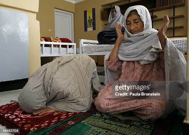Recovering female drug addicts pray during their month long detox program at the Sanga Amaj Drug Treatment Center August 28, 2007 in Kabul,...