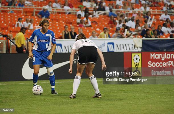 Mia Hamm of the Washington Freedom controls the ball as Christine McCann of the Boston Breakers defends in Hamm's first appearance this season due to...
