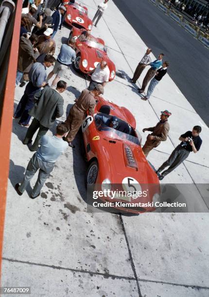 Cliff Allison settles into the cockpit of the Ferrari TR/59 he is to share with Dan Gurney during the Nurburgring 1000 km Race at the Nurburgring...